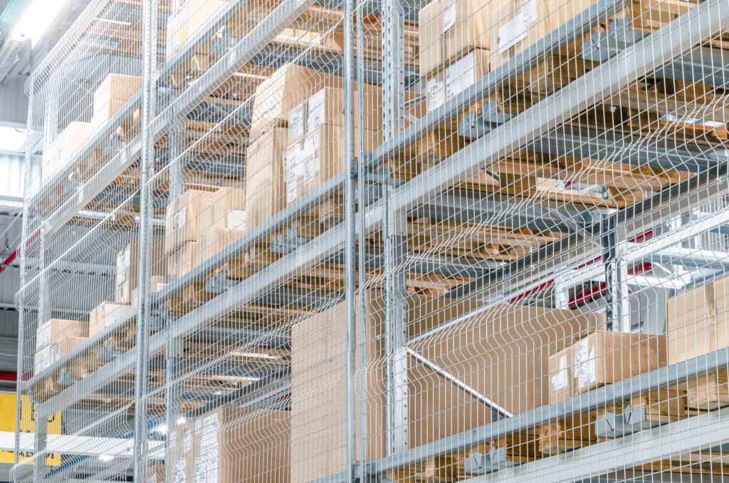 Large,Cardboard,Boxes,On,Shelves,Closed,Metal,Mesh,In,A