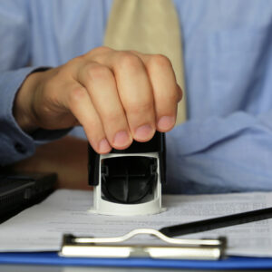 Man,In,Business,Clothes,Puts,A,Stamp,On,The,Documents